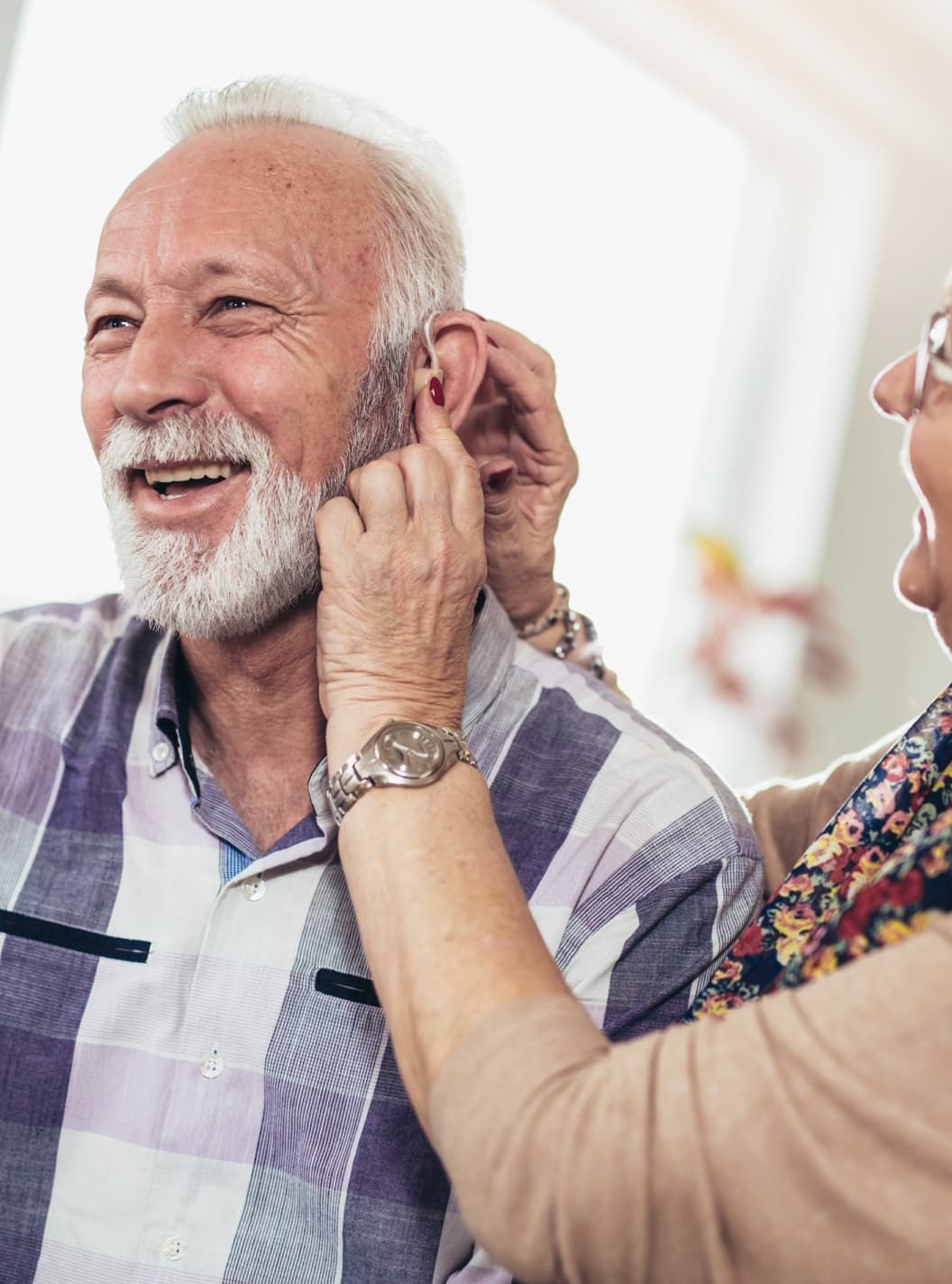 fitting a hearing aid on a person