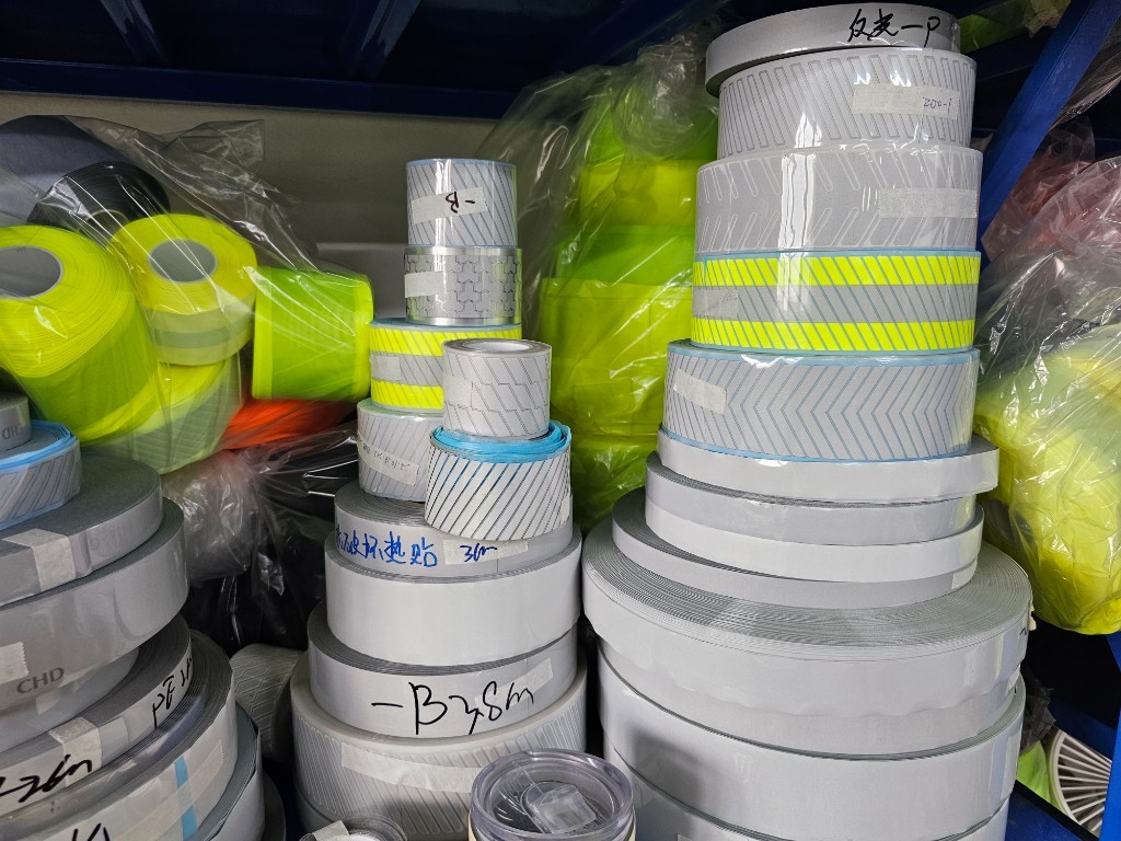 Stacks of segmented reflective tape rolls ready for hi-vis garment production