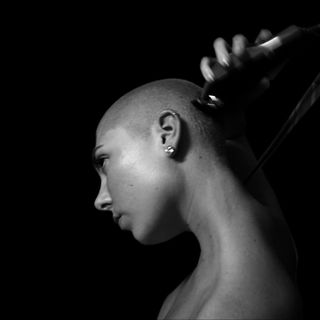 why would a woman shave her head