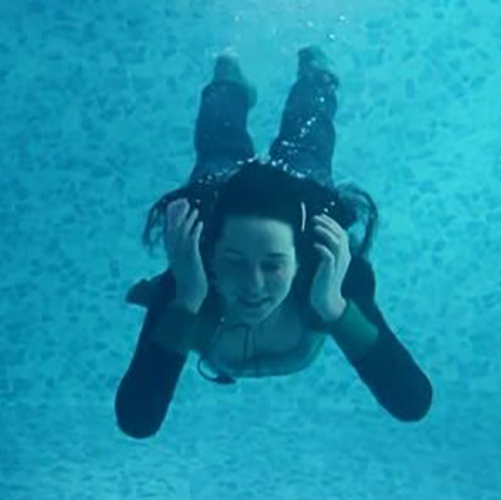Someone underwater with headphones. Not exactly deep, admittedly. She’s obviously in a swimming pool.