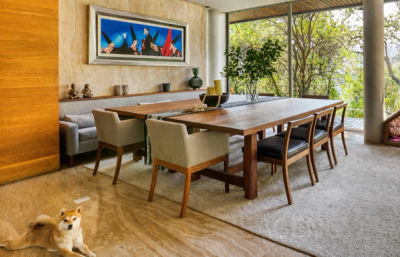 Dining area with floor-to-ceiling windows and forest views
