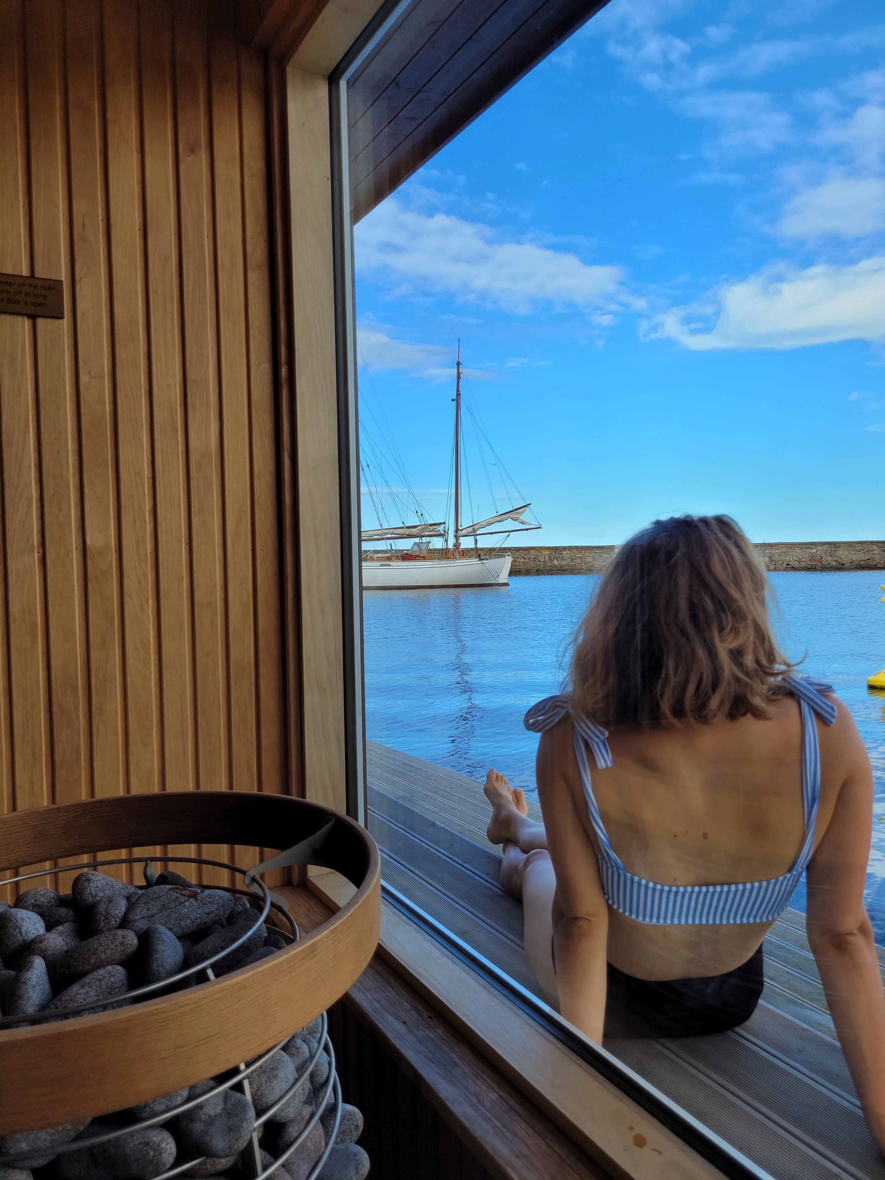 Person sitting outside the sauna