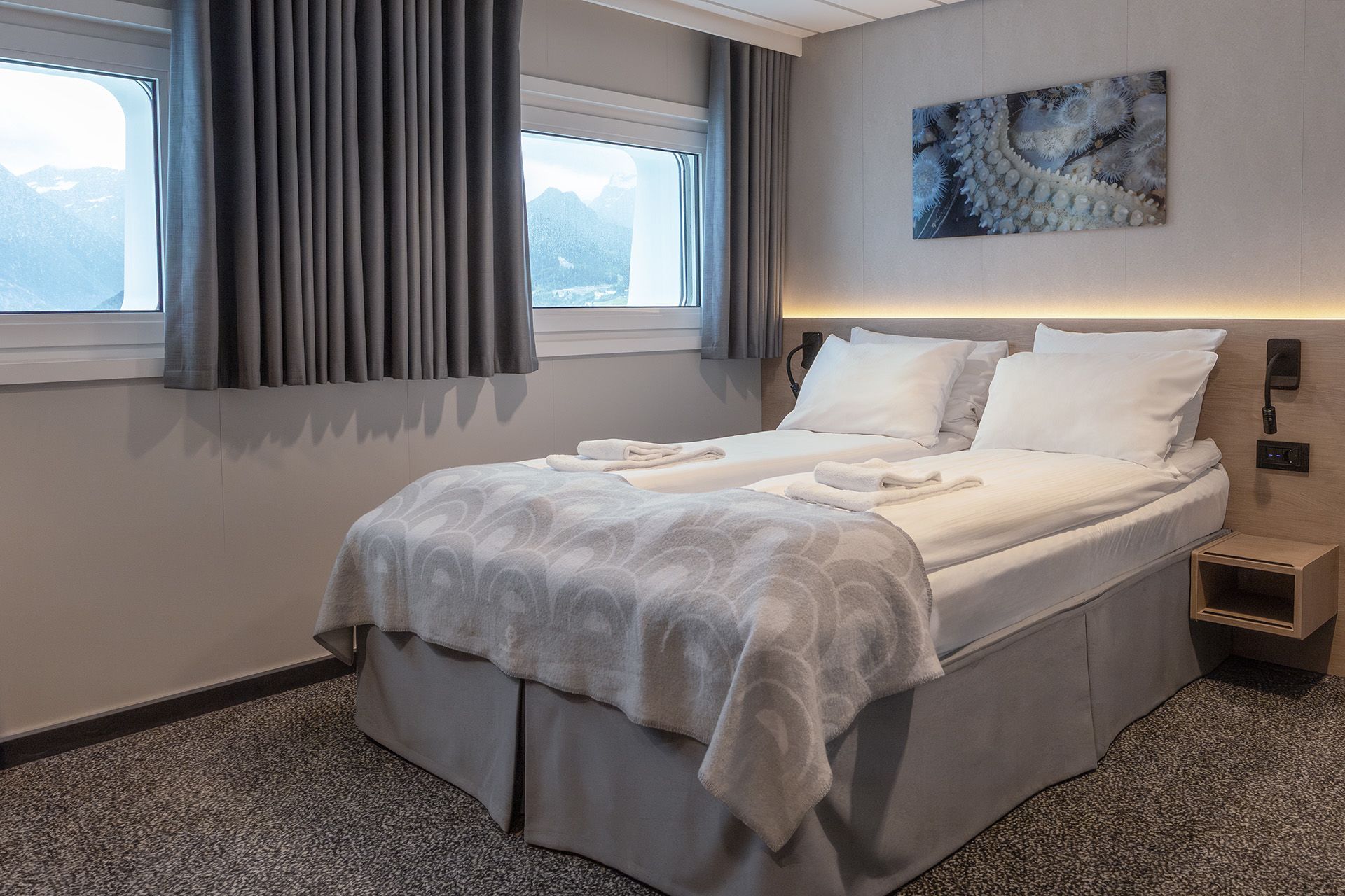 Aft View Superior Double cruise cabin with double bed, rear-facing sea view, spacious layout, and modern furnishings.