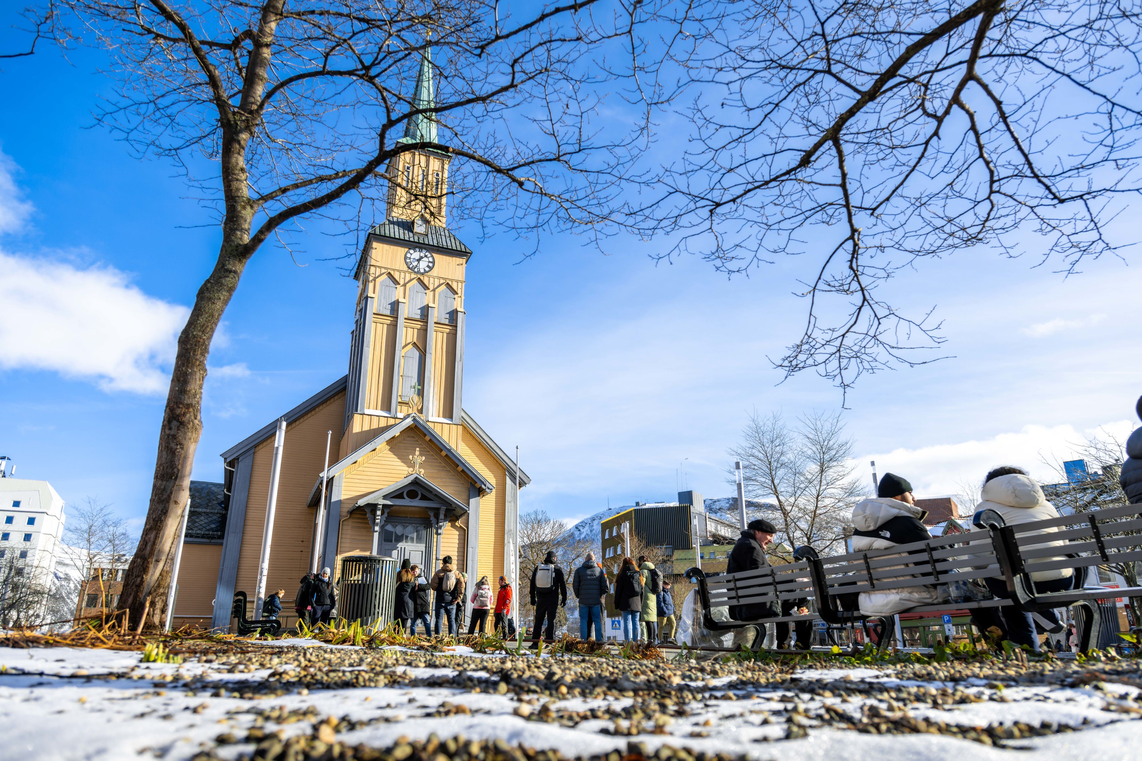 Guests gathered outside Tromsø Cathedral during a guided city walk, exploring one of the Arctic city's most iconic historic landmarks.