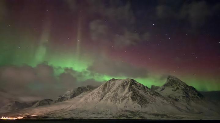 Bunte Nordlichter, gesehen von einem Havila-Schiff, das entlang der norwegischen Küste fährt.