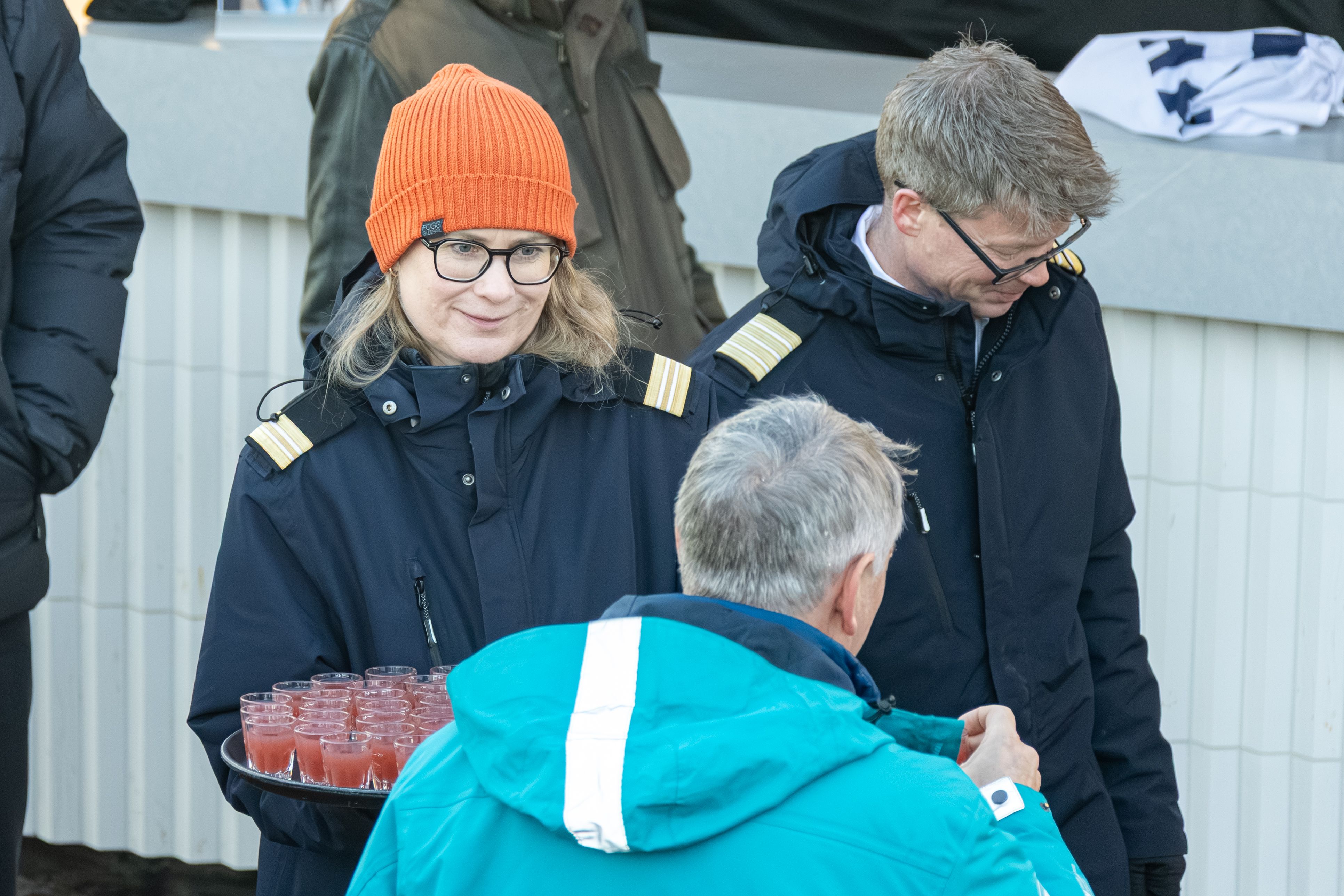 Crew serves mead at outdoor event on board