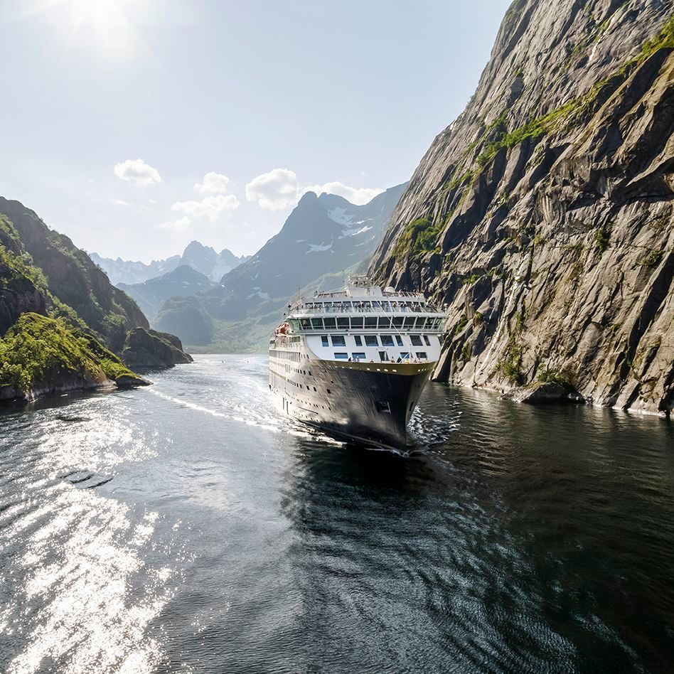 Havila Voyages coastal cruise ship sailing silently on battery power with zero emissions along the Norwegian coast.