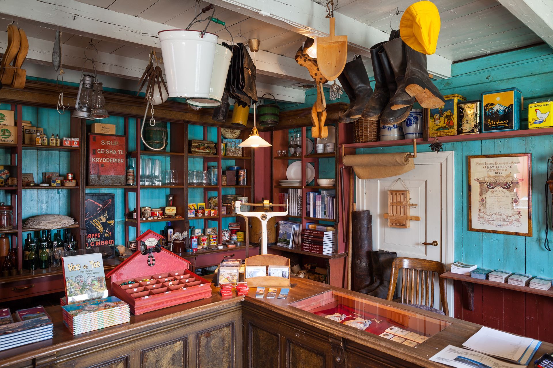 Interior of a historic general store museum with vintage goods, tins, and boots on display in Lofoten, Norway