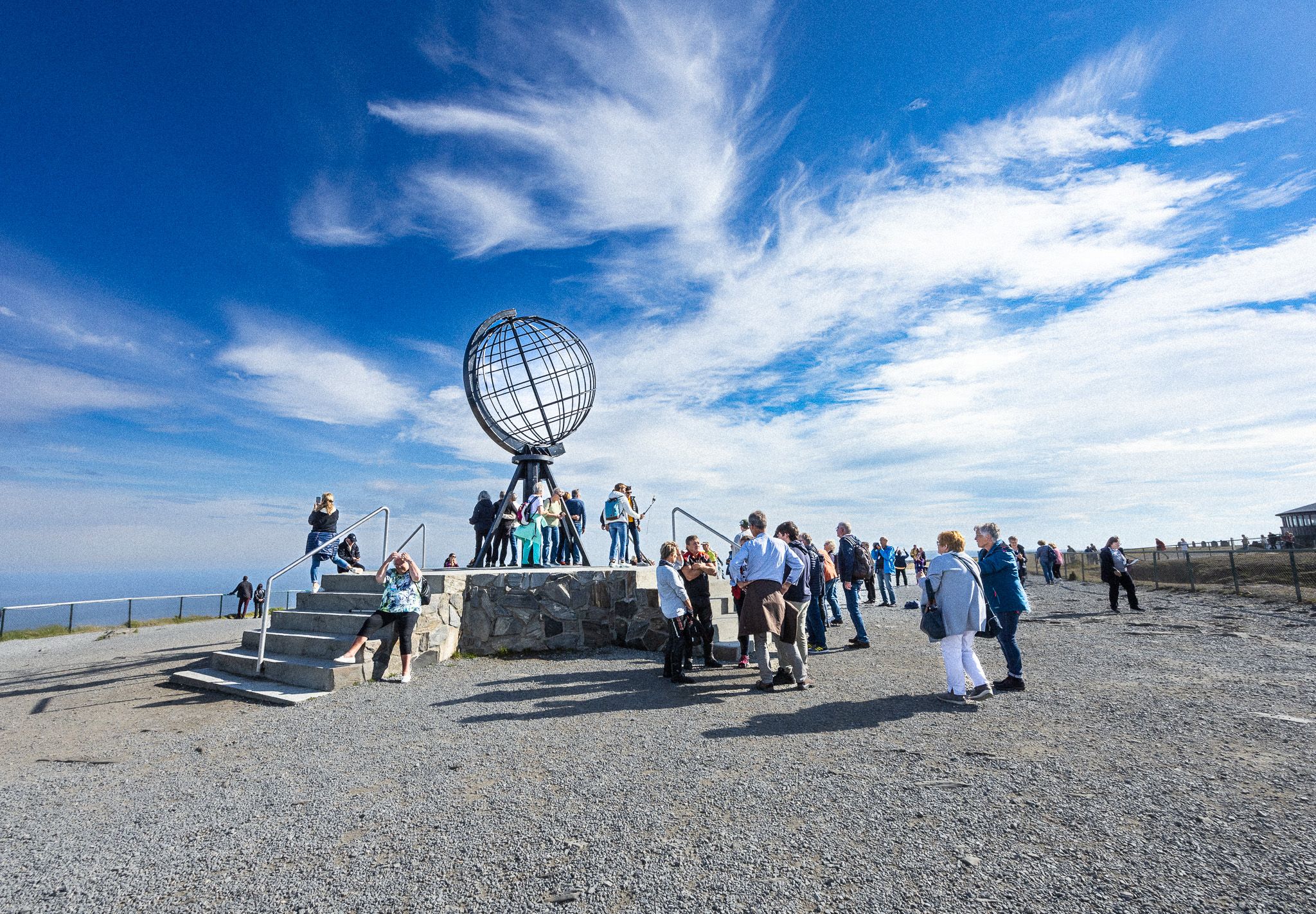 Gruppe turister ved globusmonumentet på Nordkapp
