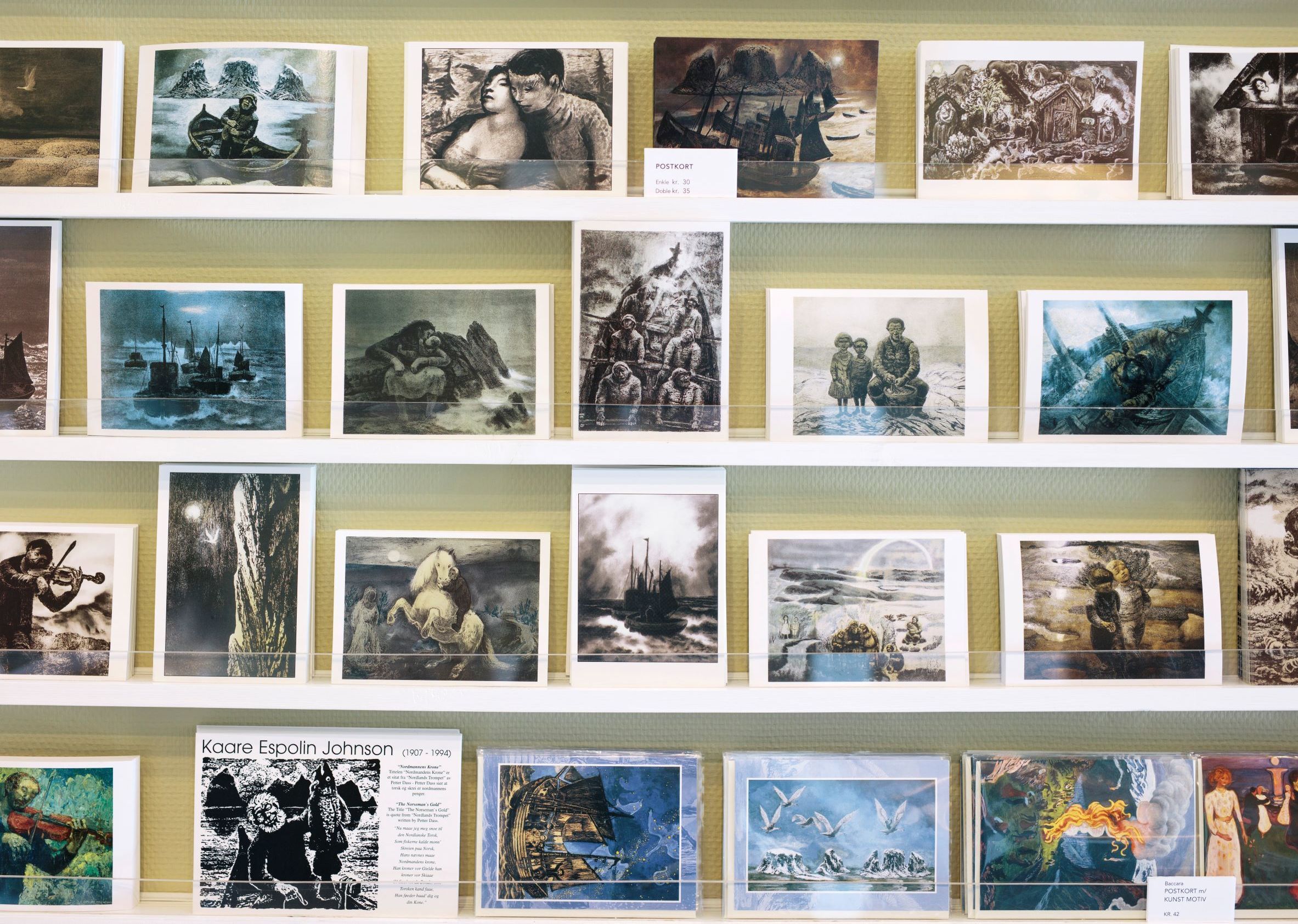 Display shelves of Kaare Espolin Johnson art postcards for sale in a gallery shop in Lofoten, Norway
