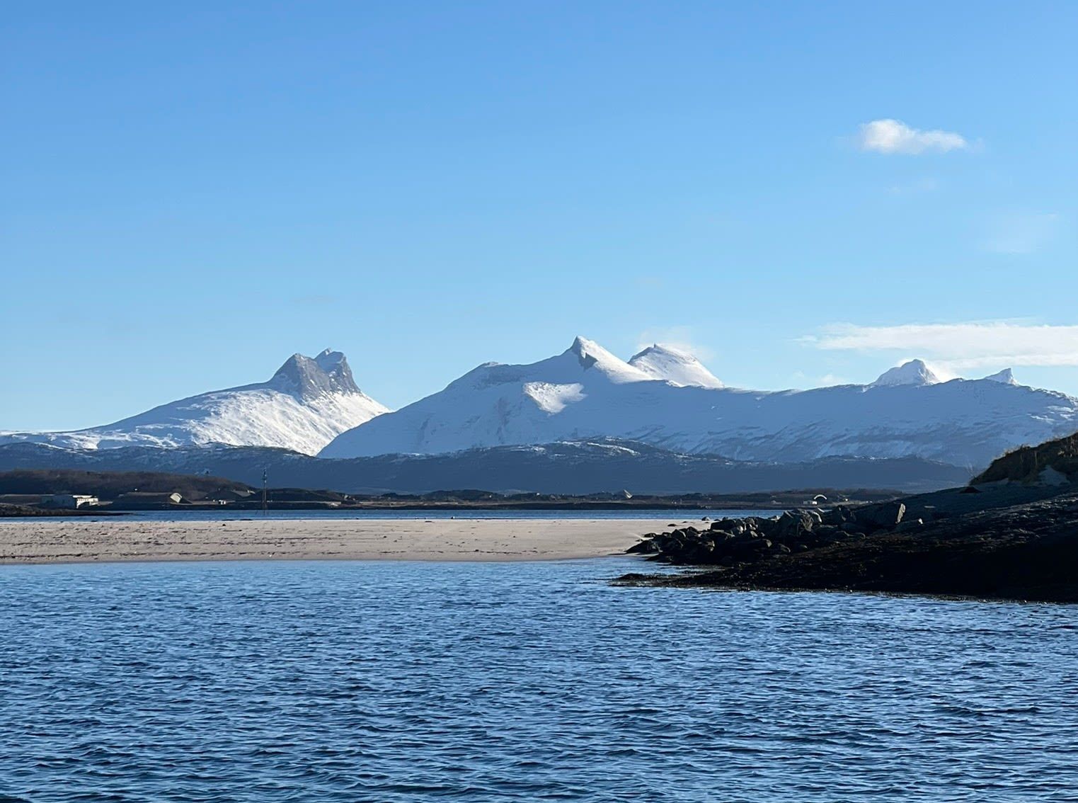 Snow-capped mountains and Arctic coastline near Saltstraumen, Bodø, Norway.