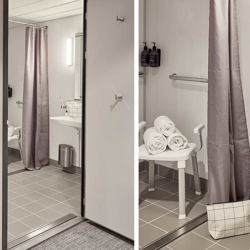 Barrierefreie Superior-Kabine mit Meerblick: Badezimmer mit begehbarer Dusche, Duschstuhl, Haltegriffen und rollstuhlgerechtem Design.