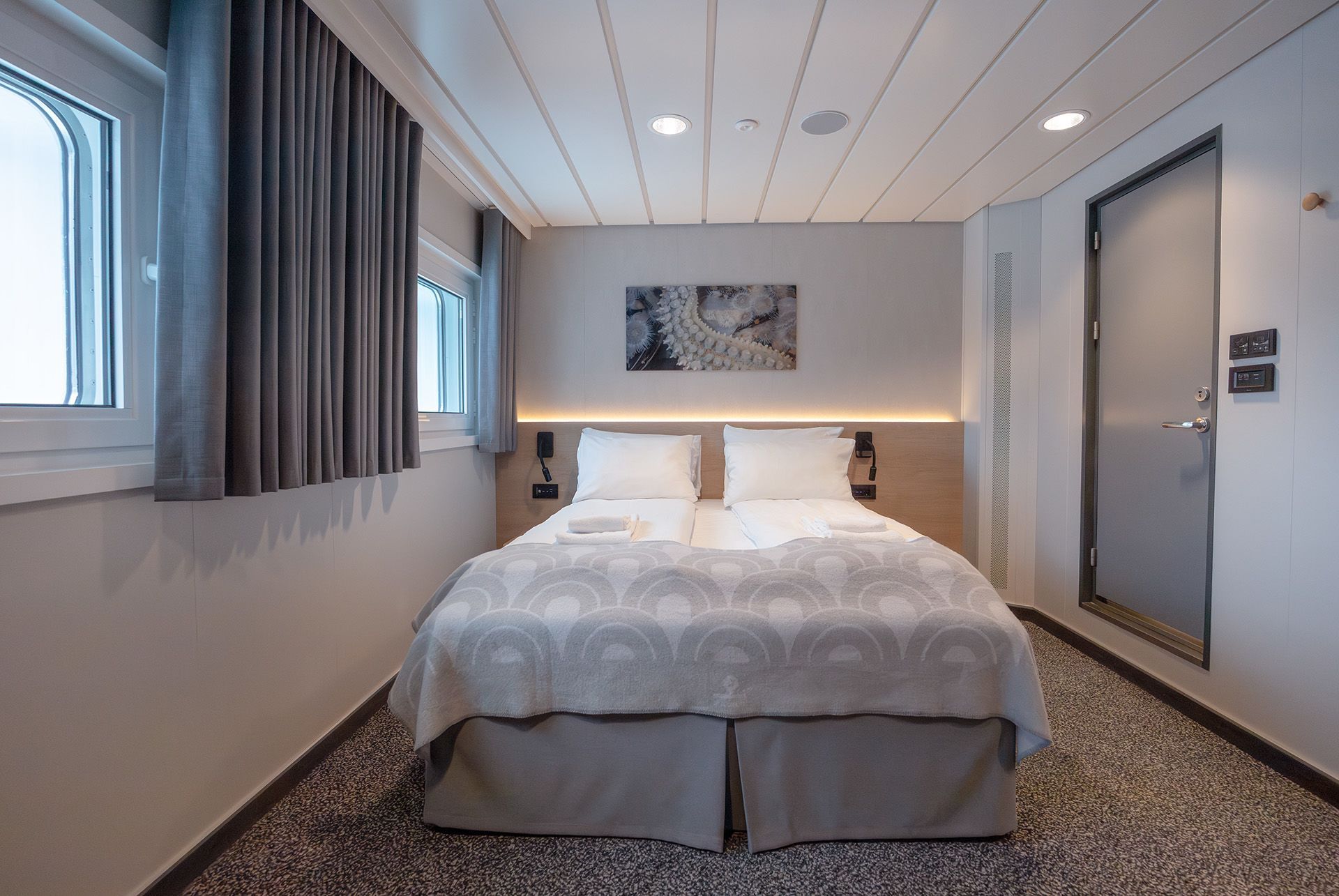 Aft View Superior Double cruise cabin with double bed, panoramic aft-facing windows, spacious layout, and modern Scandinavian design.