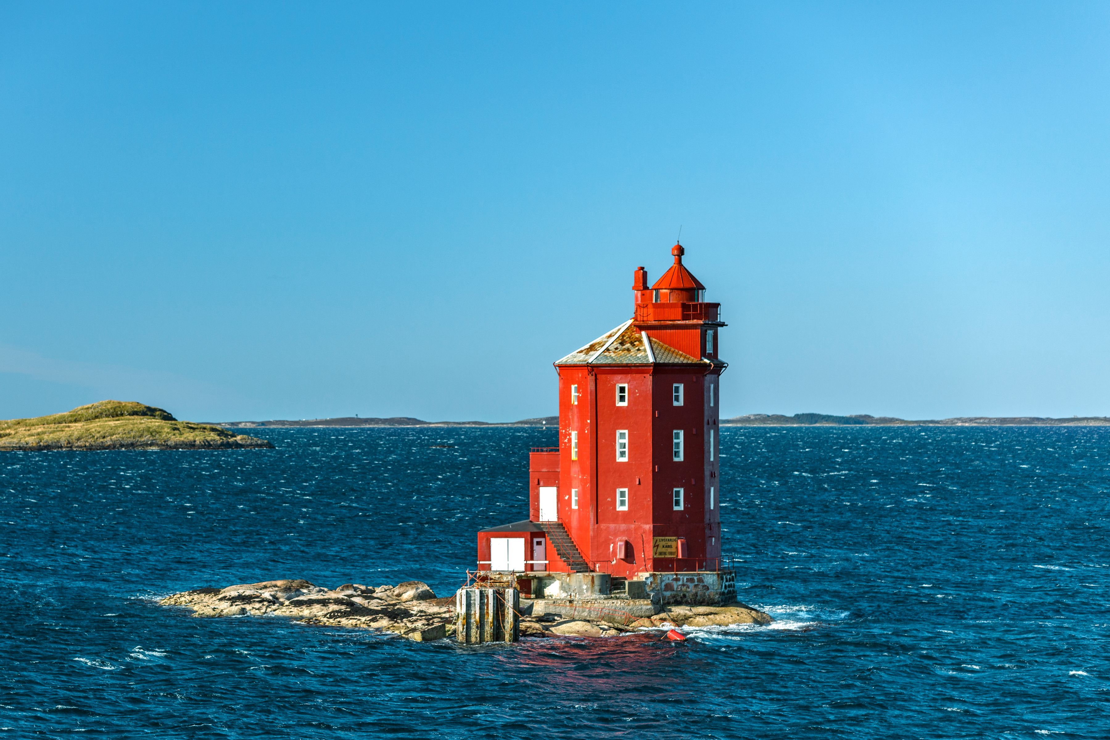 Kjeungskjær Lighthouse on a rocky islet along the Trøndelag coast, Norway, overlooking the Norwegian Sea and scenic coastal waters