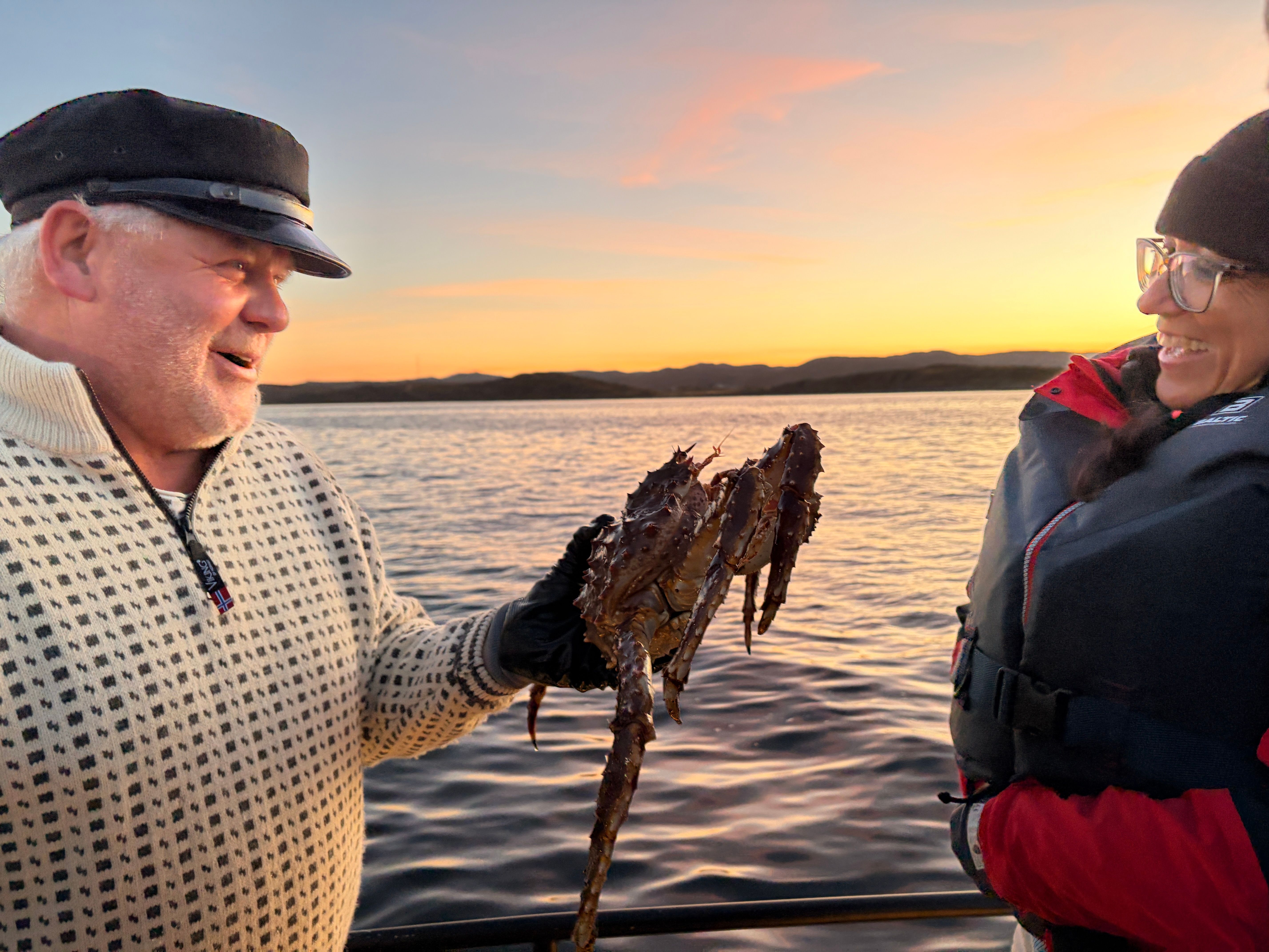 Captain showing a king crab to the guest