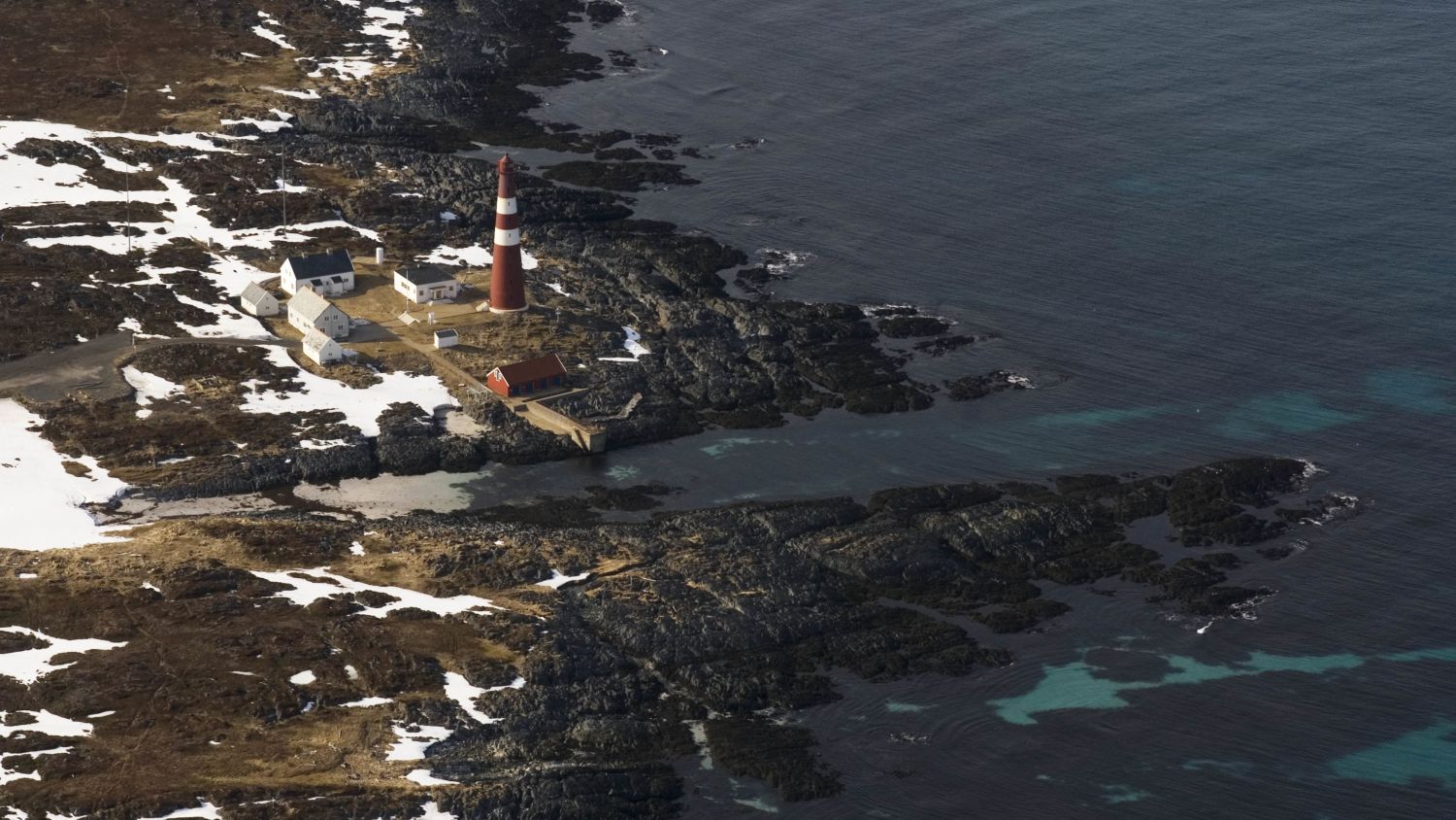 Slettnes Lighthouse in Finnmark, Norway, the world's northernmost mainland lighthouse, standing on the rugged Arctic coastline overlooking the Barents Sea