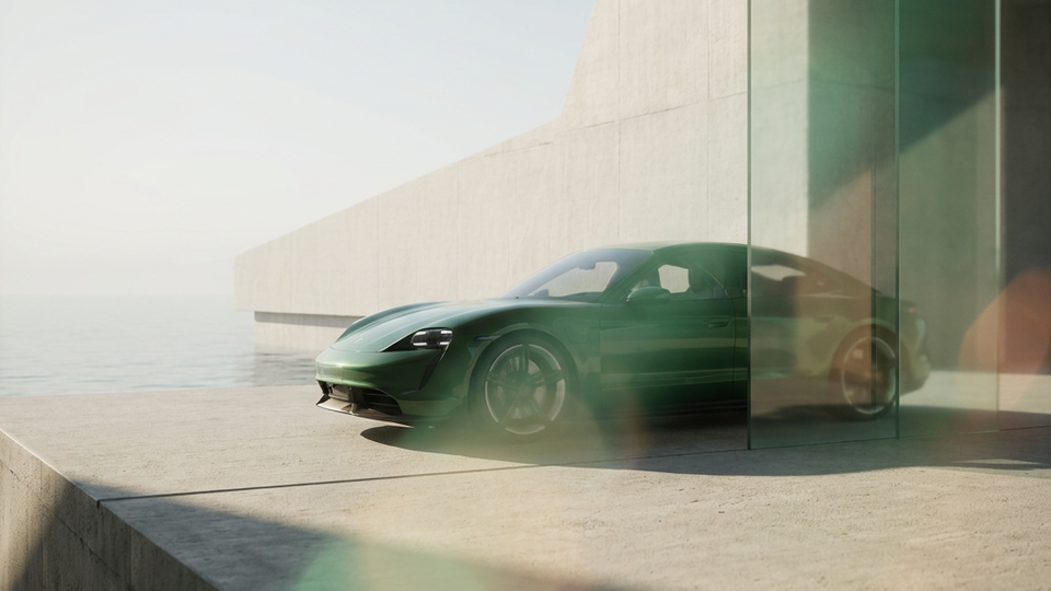 A green car in a modern architectural setting.