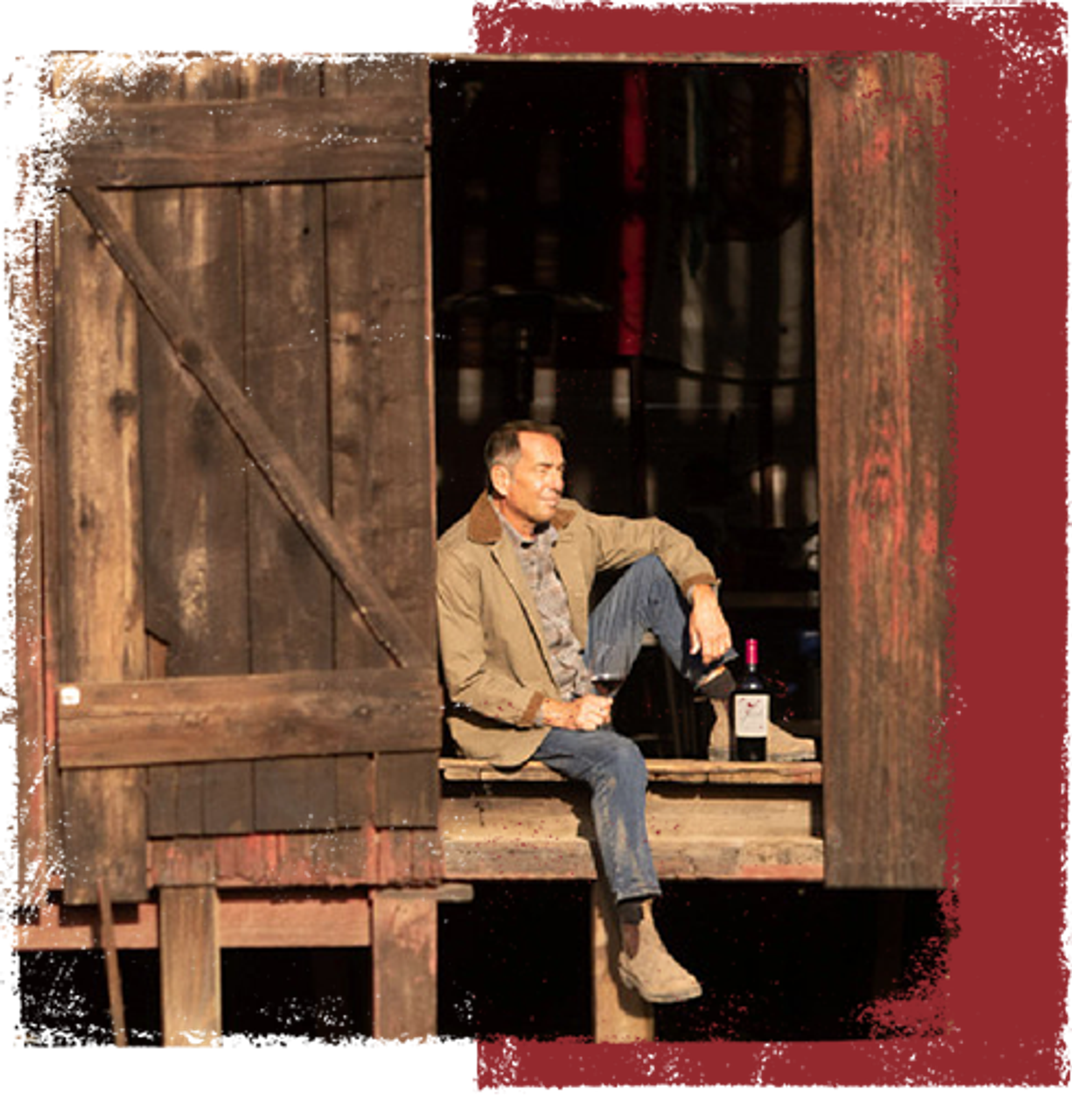 Joseph Carr drinking wine in farm setting