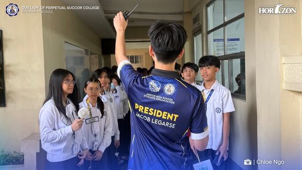 JHSSO President Jacob Legarse guides Grade 7 students during the OLOPSC Junior High School Campus Tour, introducing them to the school's facilities.