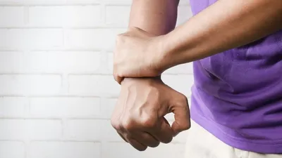 Man grabbing his wrist in pain