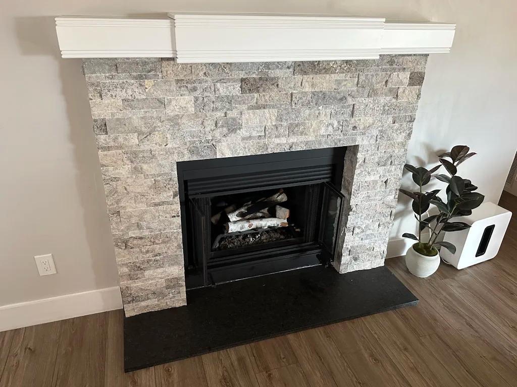 Stone fireplace with white logs
