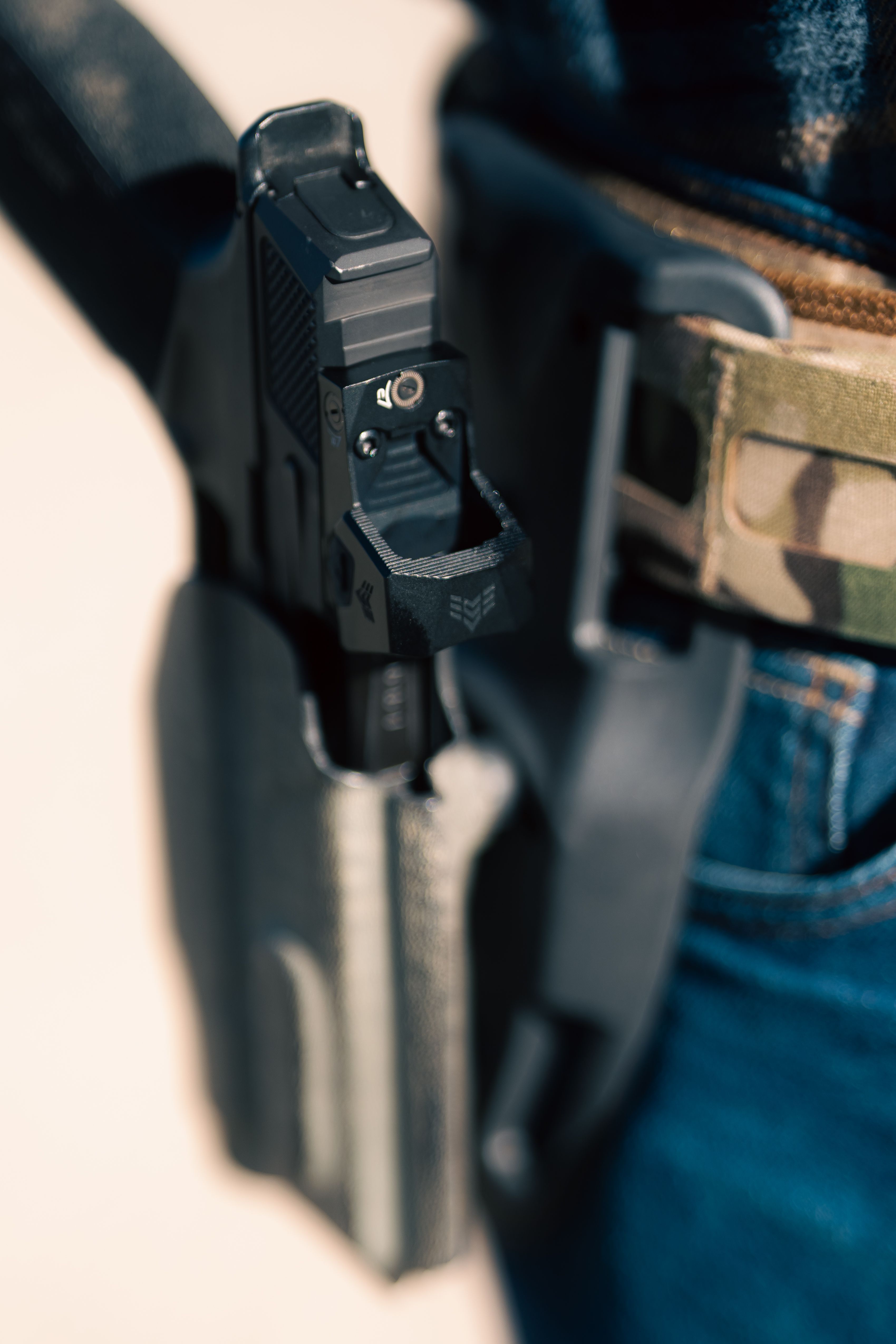 Carry Optics pistol with red dot holstered in a competition holster