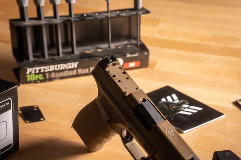 Springfield Hellcat Pro slide with the cover plate removed, showing the optic pocket, screw holes, and recoil bosses
