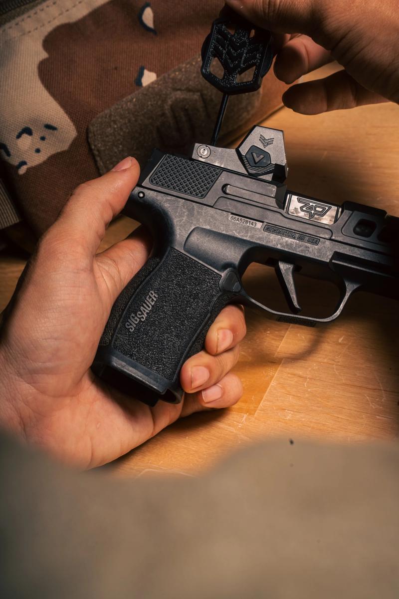 Swampfox Sentinel II on a Sig P365 slide with the mounting screws being turned in