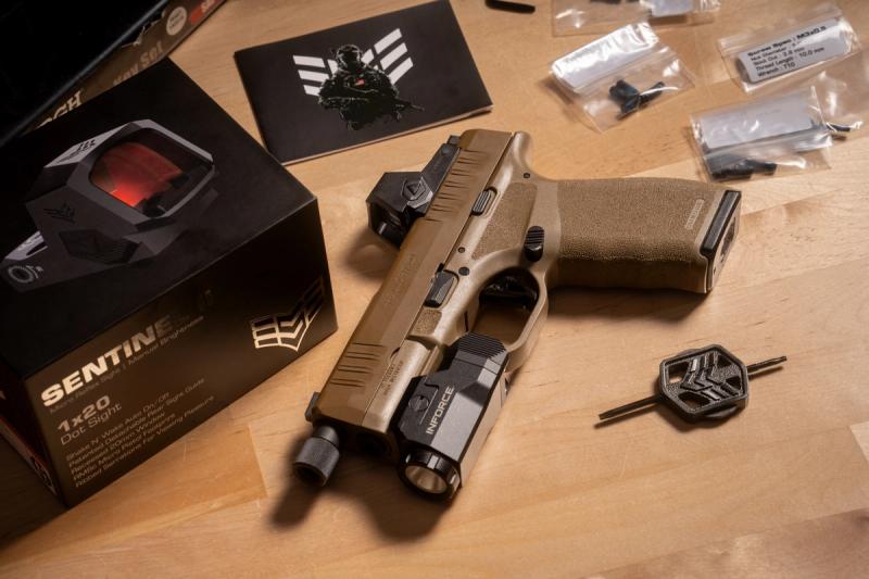 Swampfox Sentinel II mounted on an FDE Springfield Hellcat Pro with weapon light, next to the Sentinel II box and screw sets