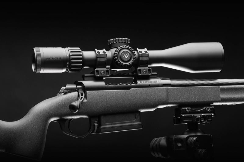 Swampfox Patriot II 6-24x50 FFP riflescope mounted on a rifle, studio shot