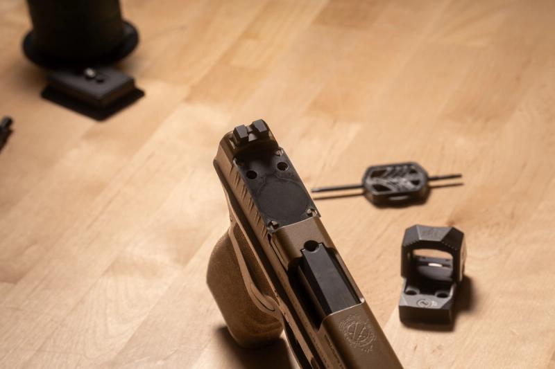Springfield Hellcat Pro optic pocket prepped for mounting, with the Swampfox Sentinel II and adjustment tool on the bench beside it