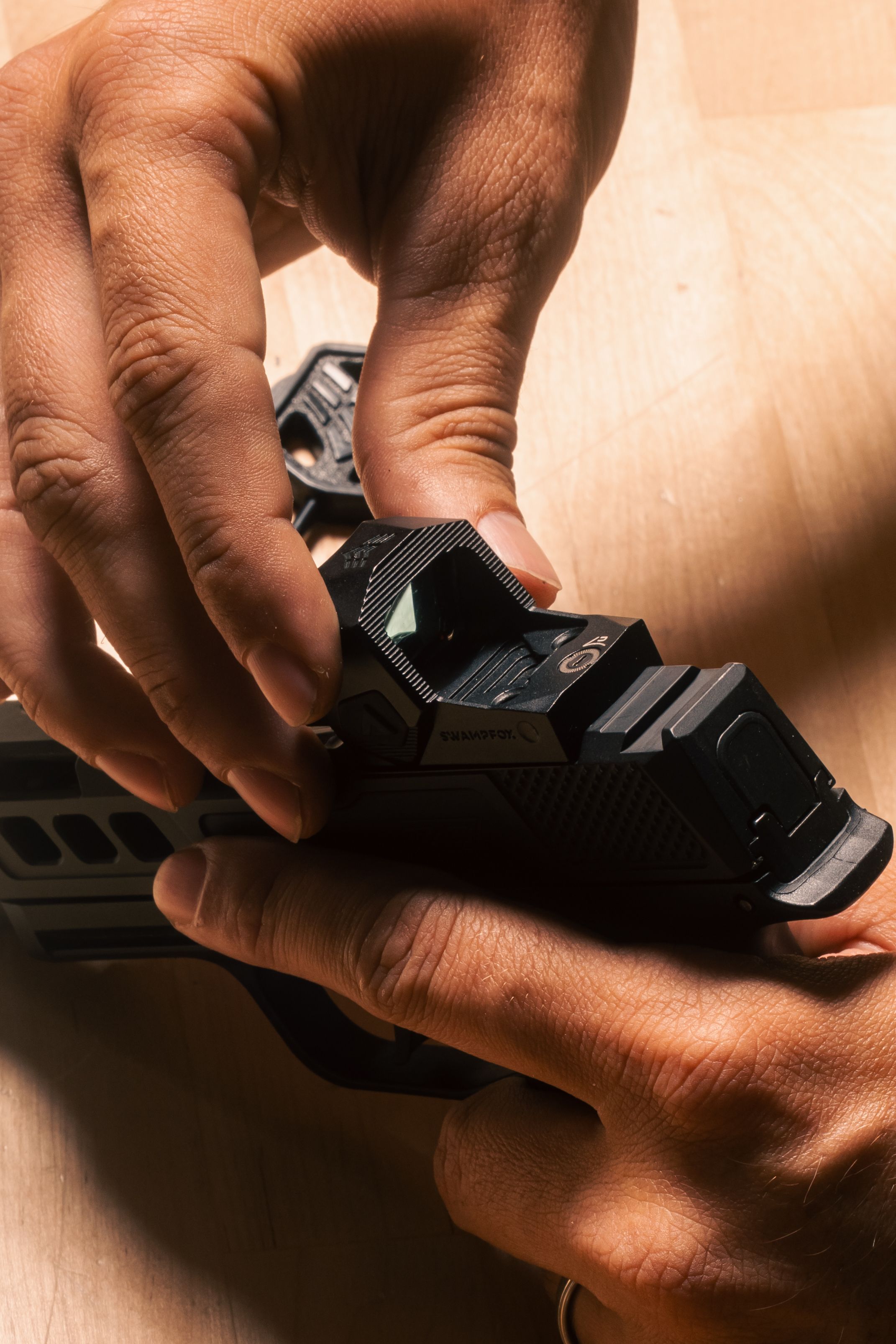 Swampfox Sentinel II being placed on a Sig P365 slide by hand