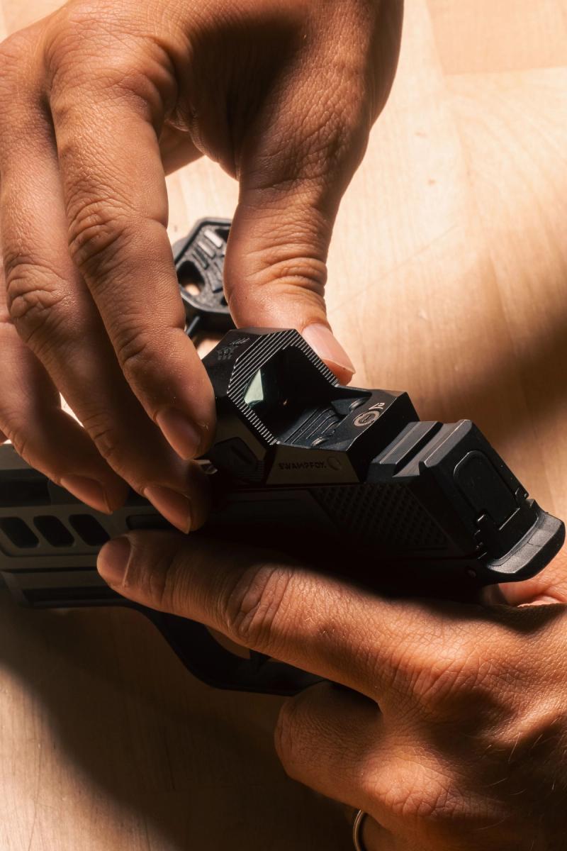 Swampfox Sentinel II being placed on a Sig P365 slide by hand
