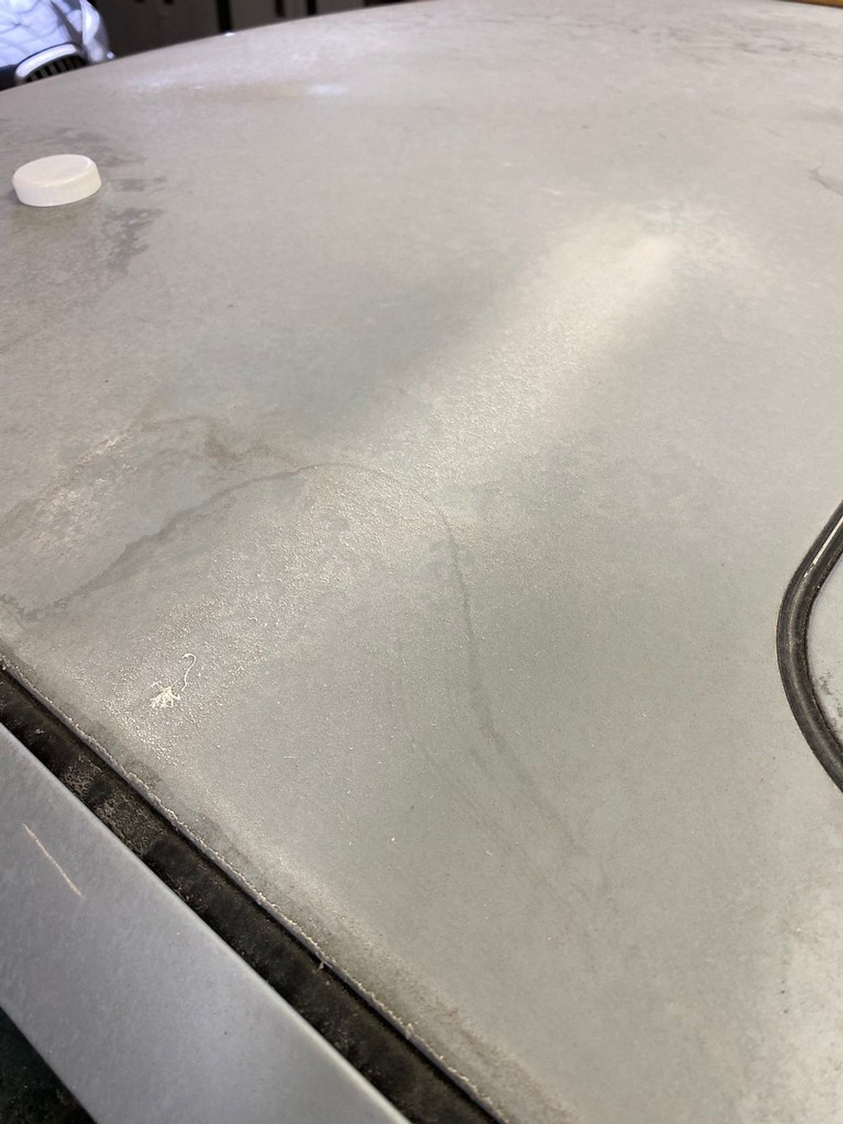 Roof of a silver 1997 BMW M3 covered in dried mineral rings and water spot staining before decontamination
