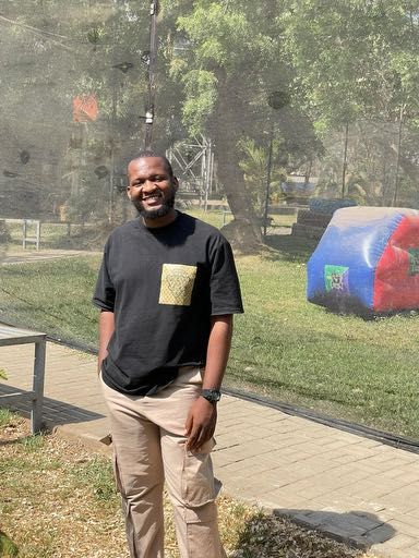 Evans Agina standing outdoors