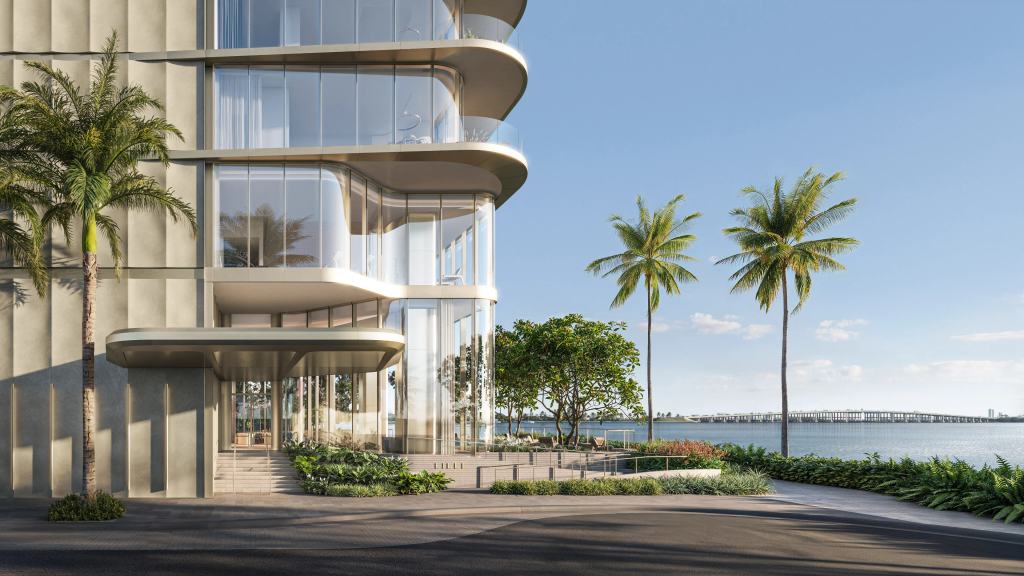 LILLI’s entrance canopy and glass lobby at the base of the tower, with palms and Biscayne Bay beyond.