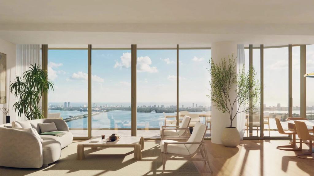Bright living and dining room with floor-to-ceiling windows overlooking the bay.