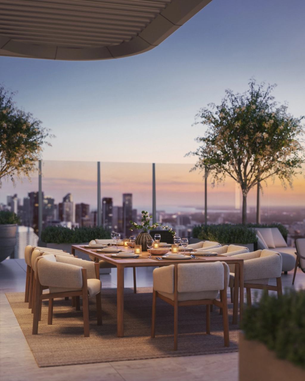 A stylish rooftop dining area with a set table and cushioned wooden chairs overlooking a city skyline at sunset