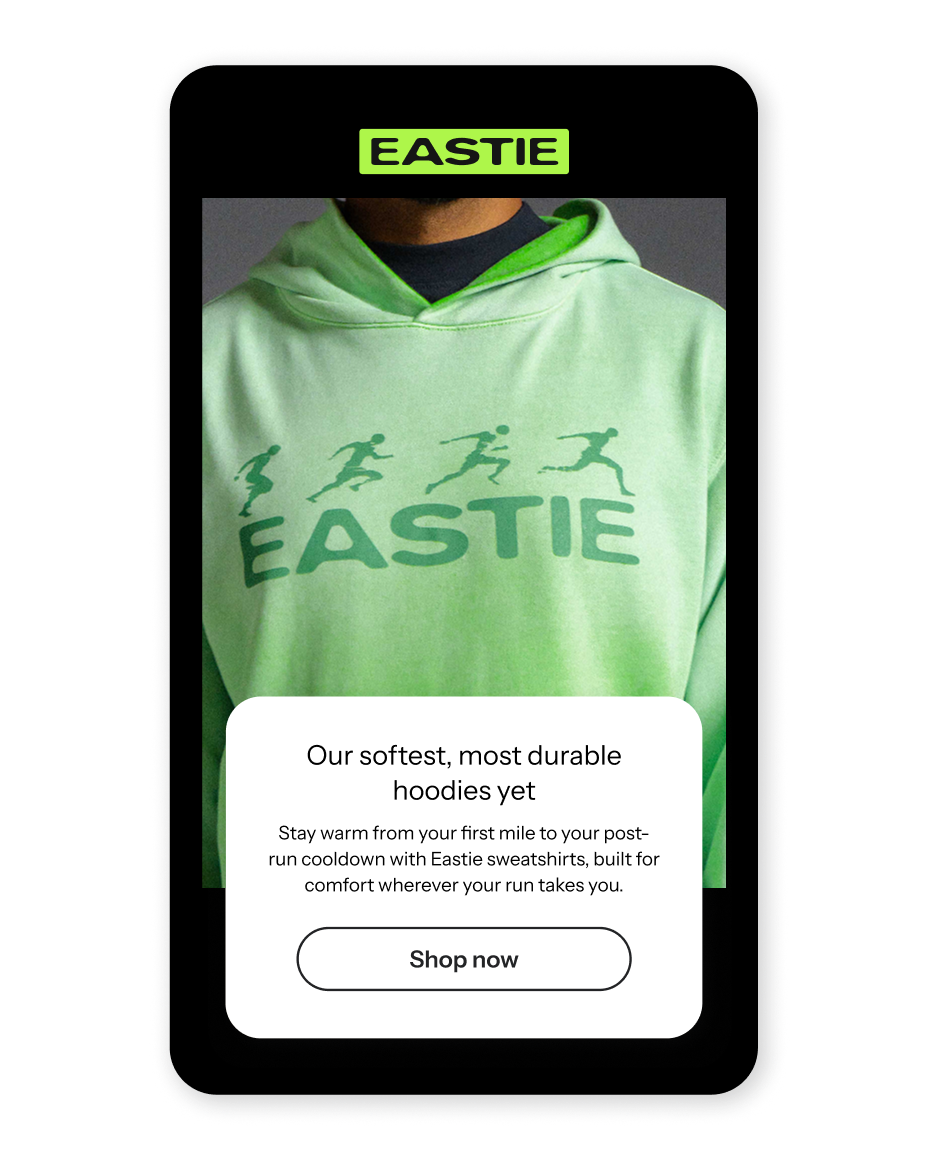 A mobile ad for Eastie featuring a light green hoodie with running figures, text promoting "softest, most durable hoodies" and a "Shop now" button.