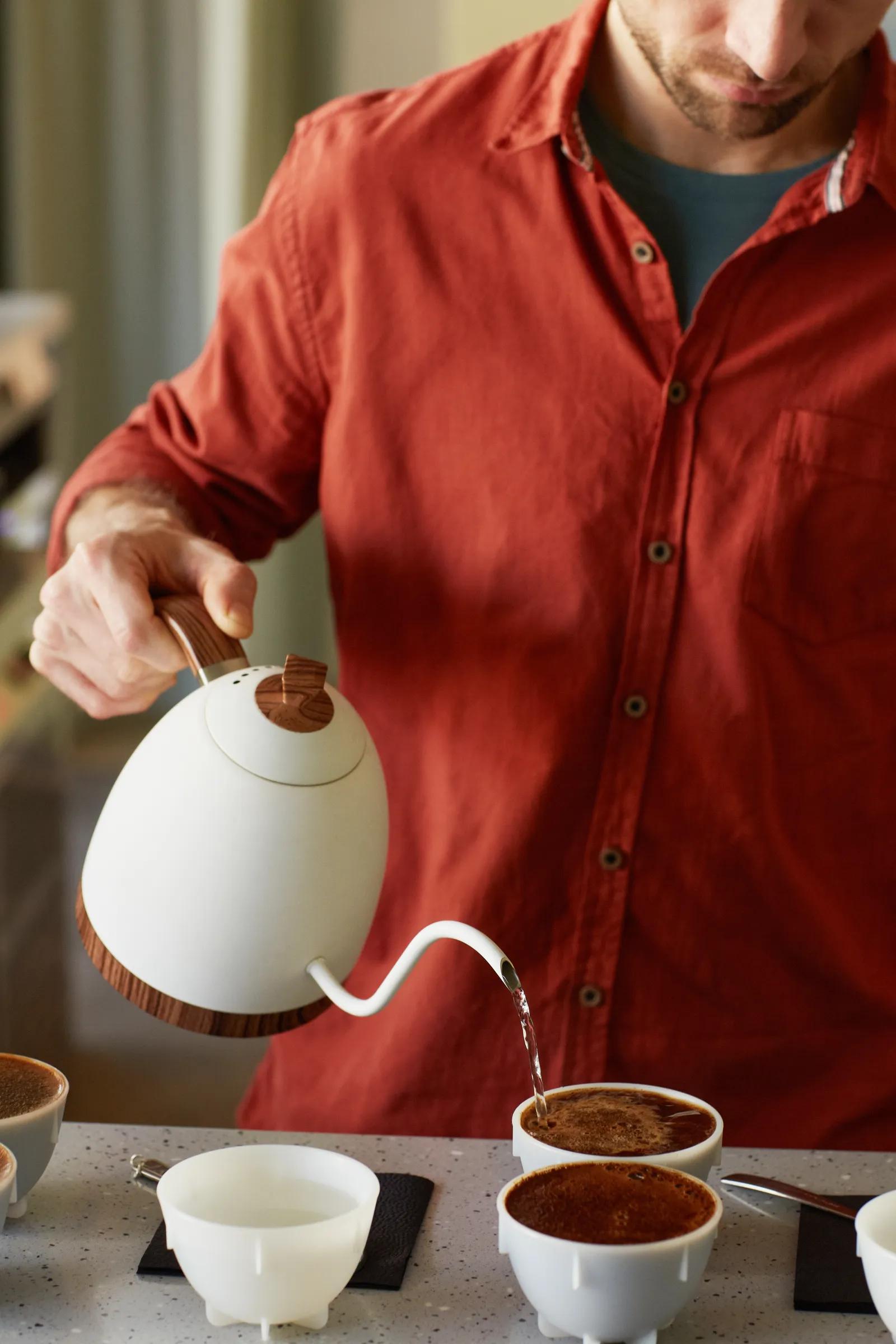 Image of a middle aged-man pouring coffee.