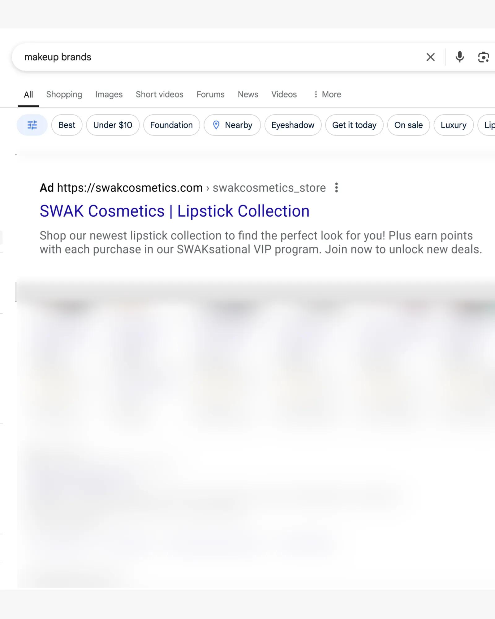 Example of a text-based SWAK Cosmetics ad appearing at the top of search results.