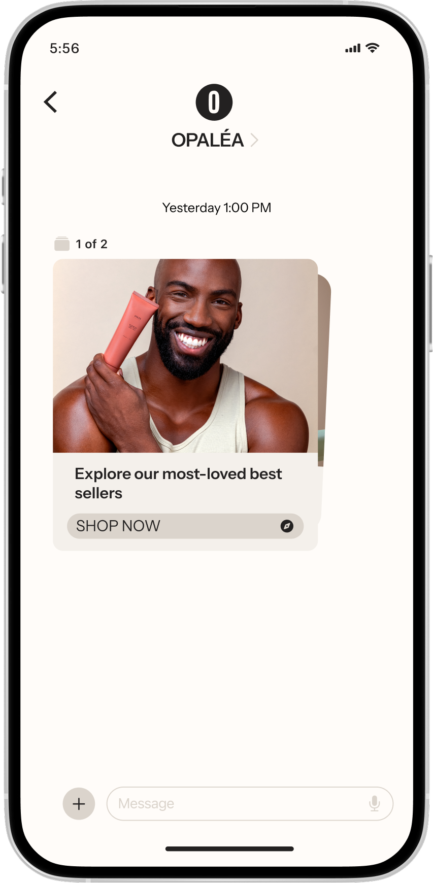 A smartphone displays an RCS from OPALÉA featuring a smiling man holding a makeup product, with a "SHOP NOW" button.