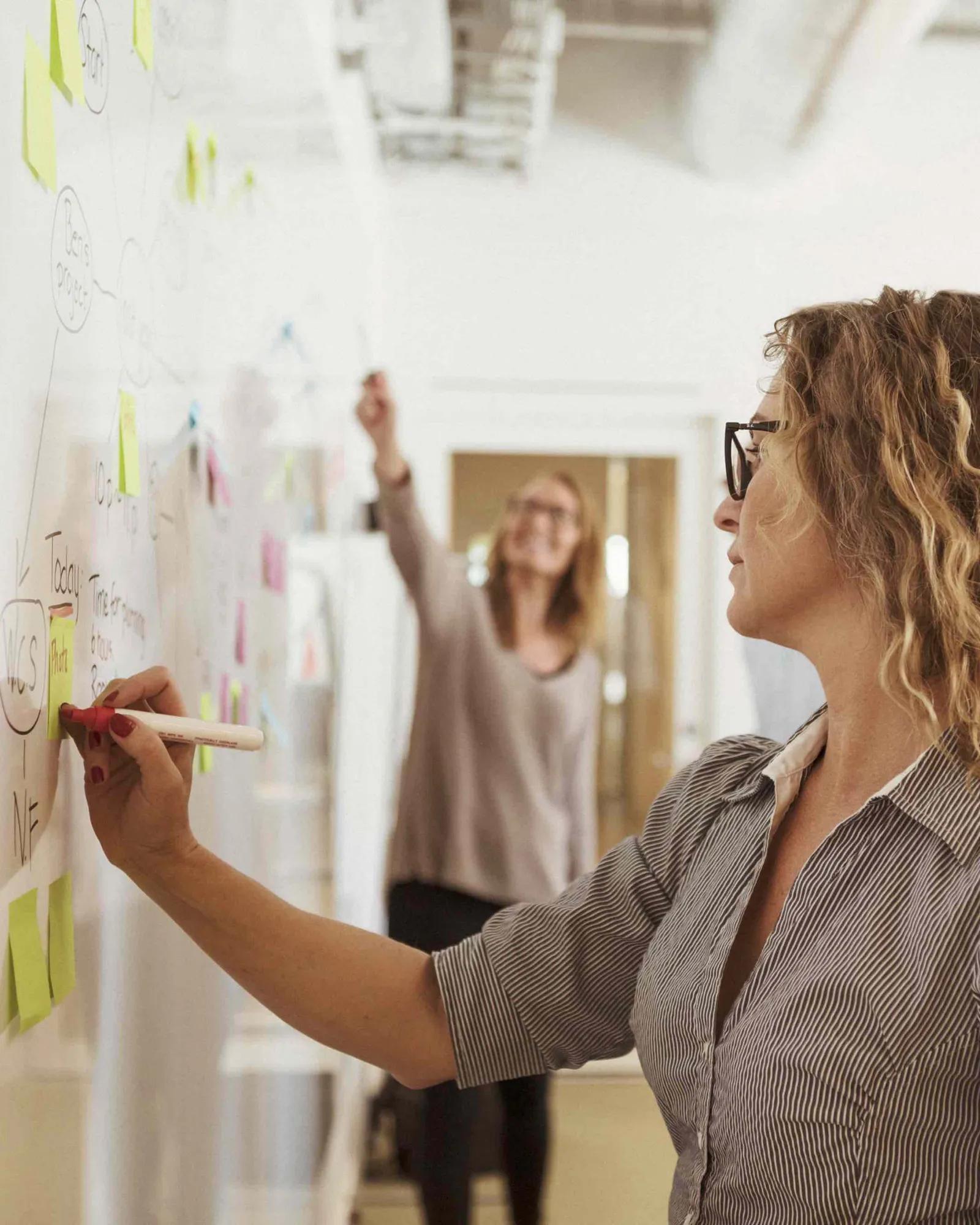 Woman writing down notes.