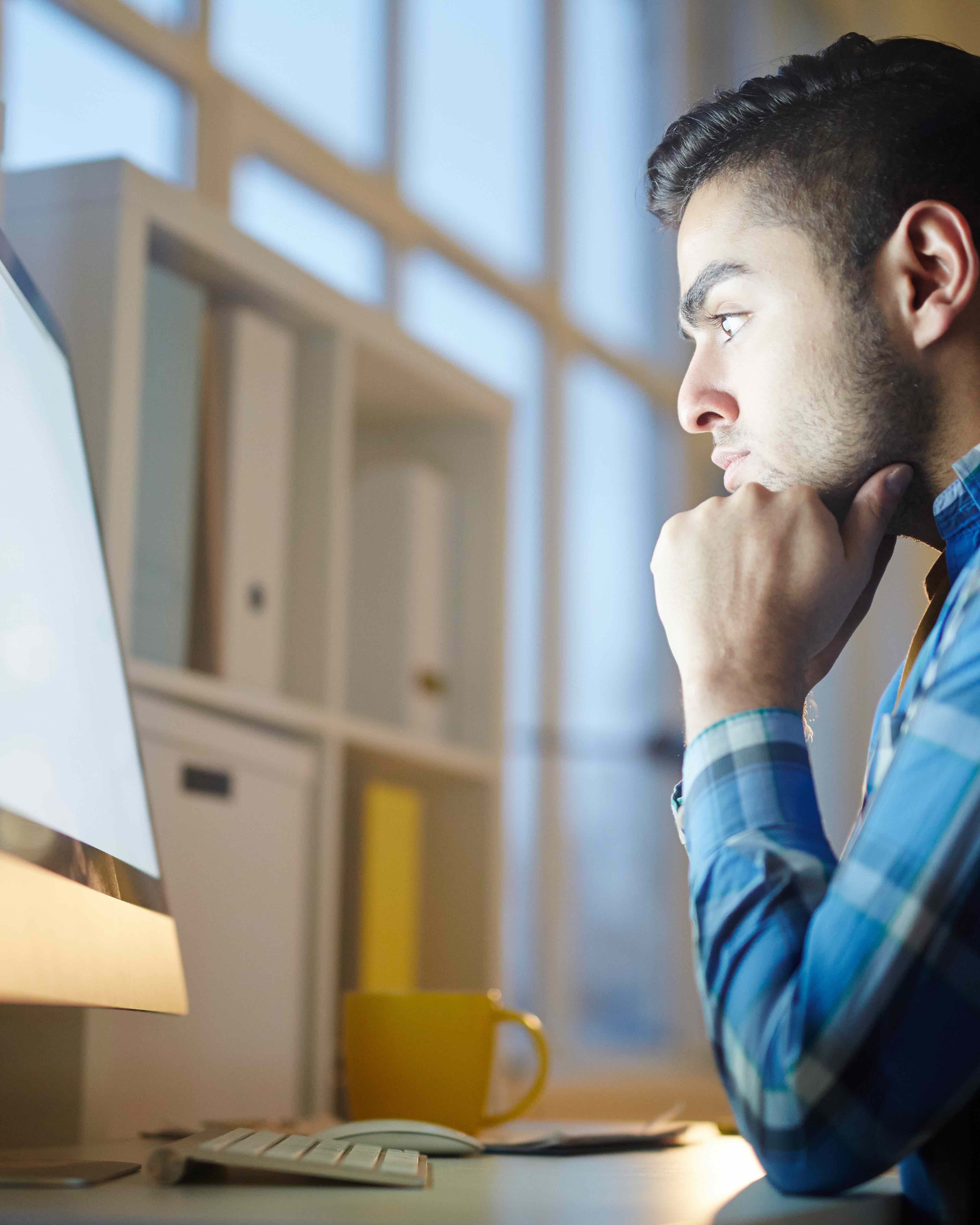 A man focused at his computer.