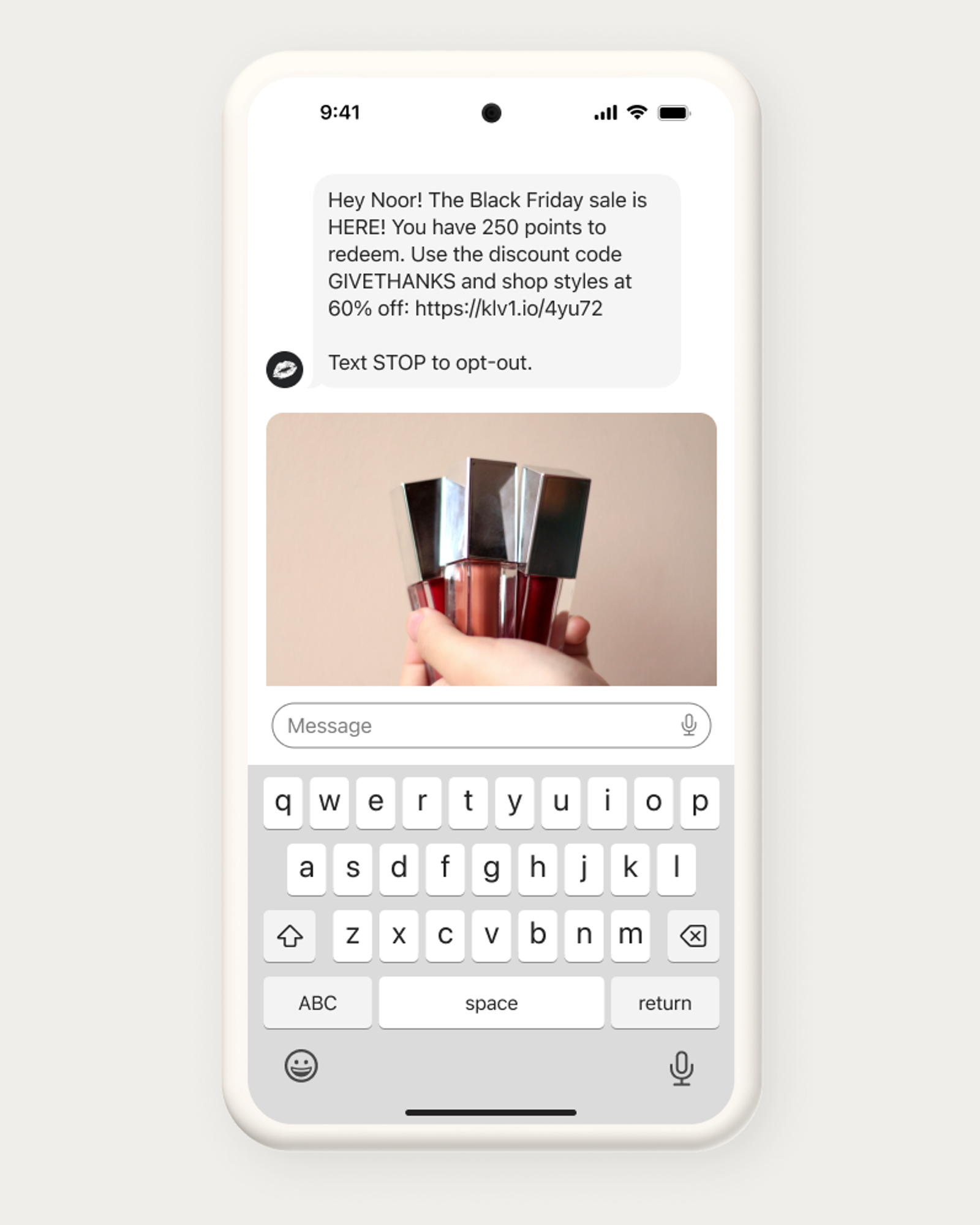 A smartphone screen showing a text message about a Black Friday sale with a photo of a hand holding four bottles of lip gloss.