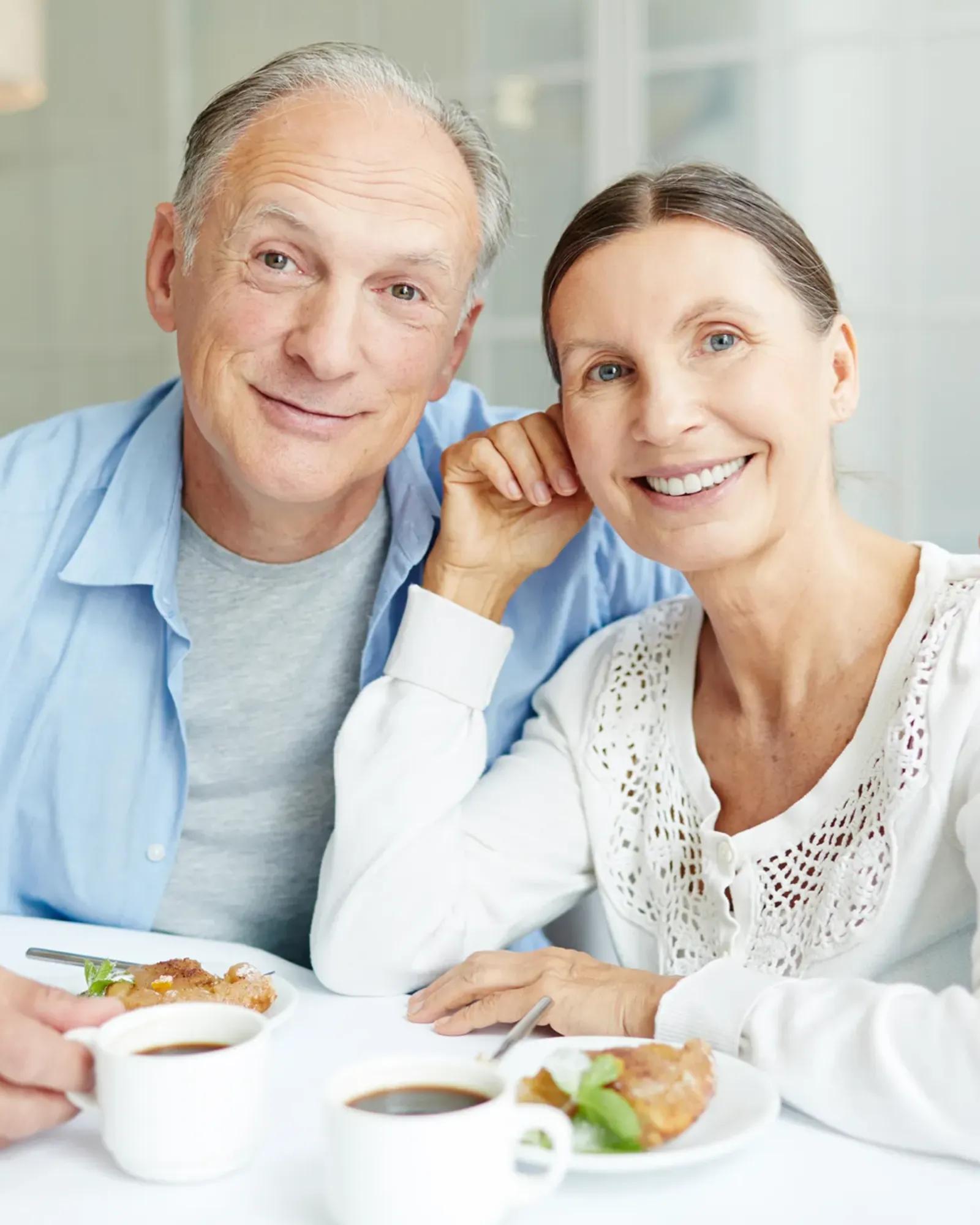 Image of an elderly couple enjoying coffee together.