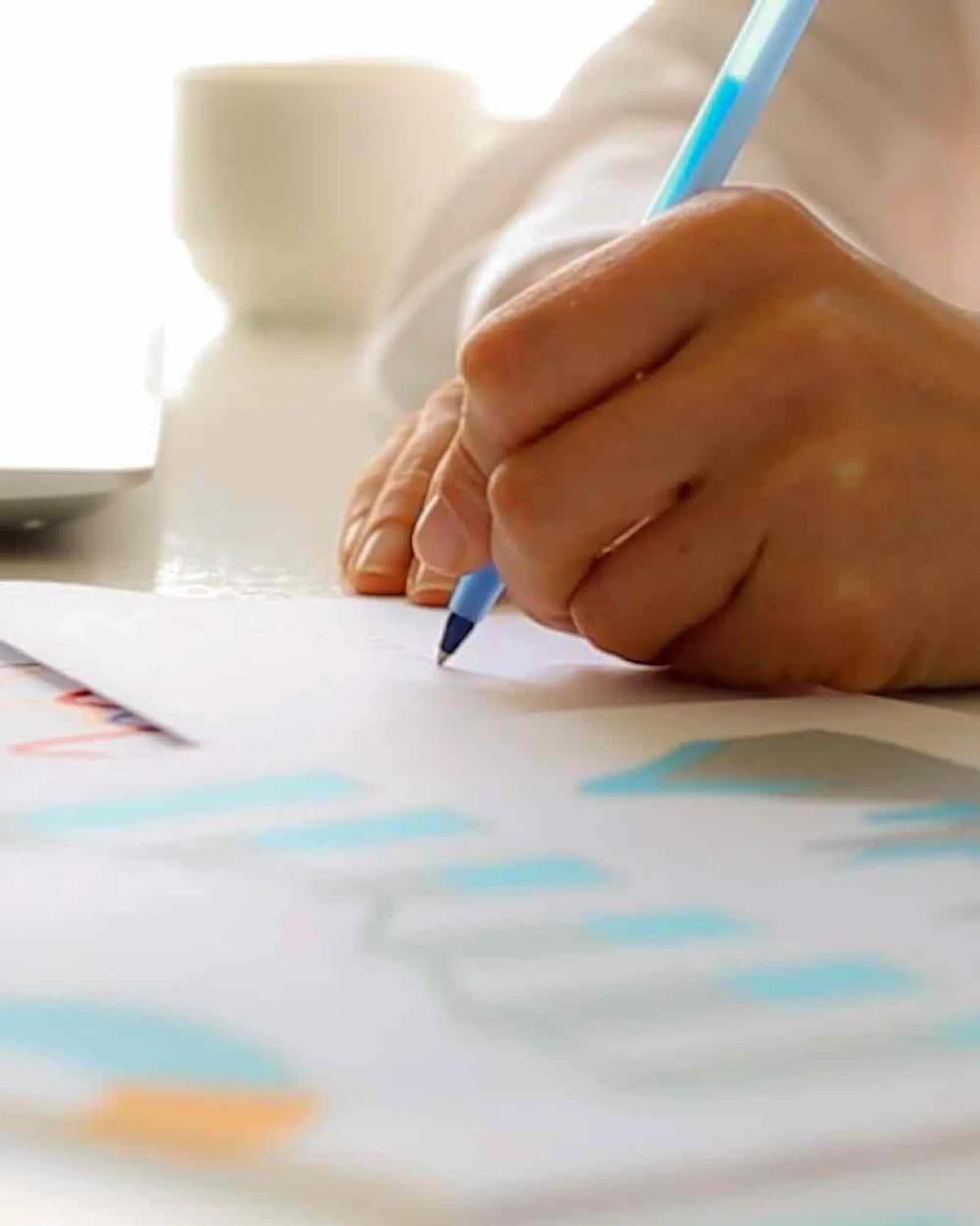 Someone looking through data and taking note.