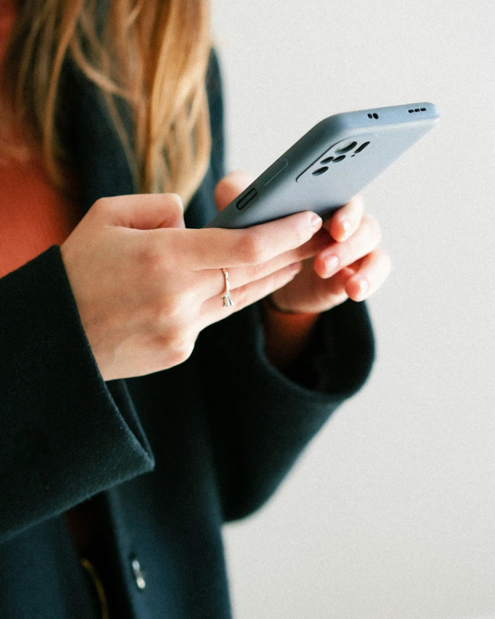 close-up on a consumer looking at their phone