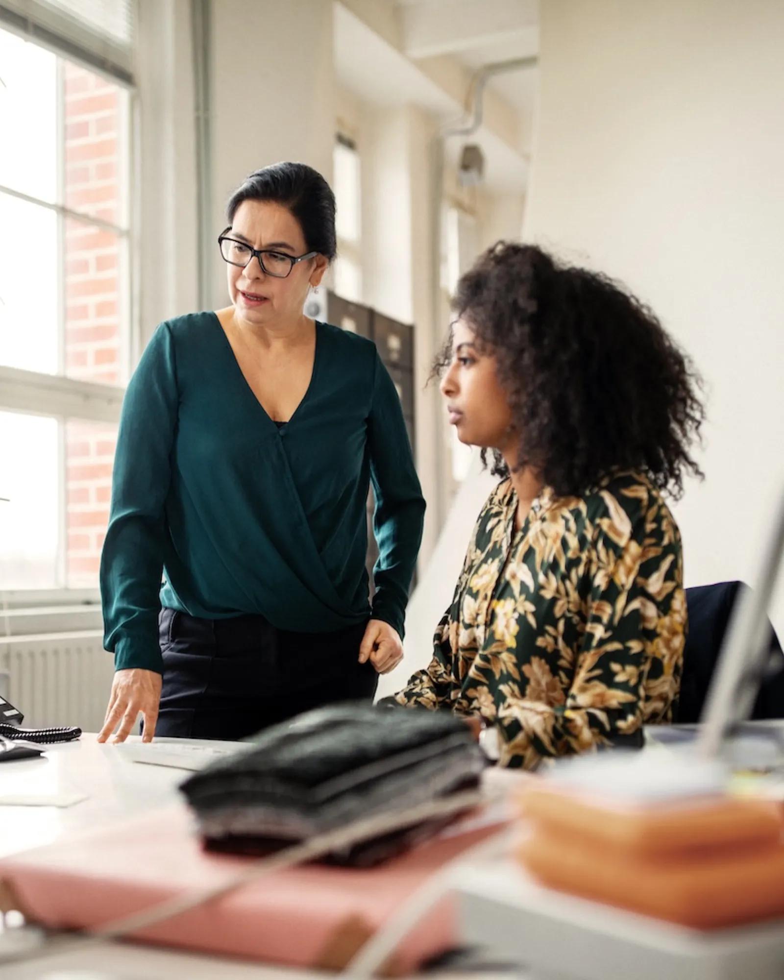 Two women at a desk.