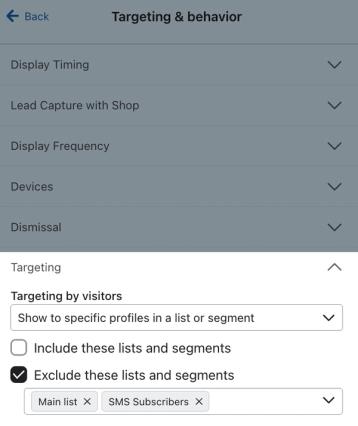 The Targeting by visitors setting for an example form set to Show to specific profiles in a list or segment and exclude those already in a the Main list and SMS list.